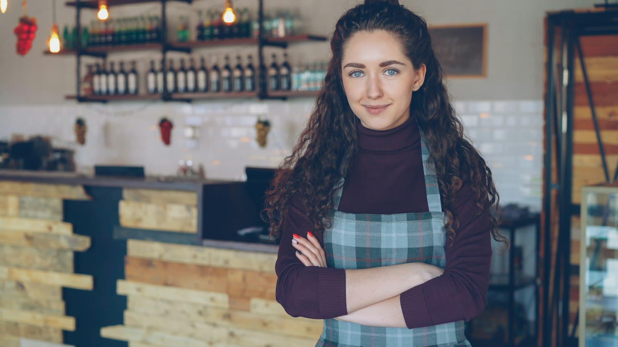Café owner standing behind her counter